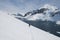 Lonely man walking along the snow slope