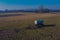 A lonely manure tank or cistern standing in the middle of the field. Some fertilizer was spilled around the tank