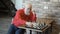 Lonely mature man play chess with himself