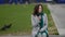 lonely middle-aged woman is sitting on bench outdoors in city, single lady