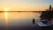 Lonely motorboat on a frozen river at dawn