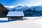 Lonely mountain hut in sweeping snow landscape