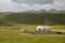 Lonely nomadic yurt and sheep in the pasture