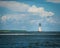 Lonely old lighthouse shot from sea near Tybee Island in Georgia on sunny day