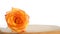 Lonely orange rose on wooden table