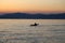 Lonely paddler on the lake during the sunset.