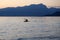 Lonely paddler on the lake during the sunset