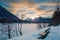 Lonely park bench at sunset in alps