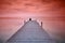 Lonely person sitting on pier