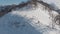 Lonely person with snowboard walking to unusual place to ride. Magnificent panoramic shot of peaks covered in snow