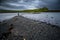 Lonely Person On Stony Sandbank At Low Tide On The Isle Of Skye In Scotland