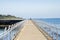 Lonely Person Waking along the Walkway on the Top of Breakwater