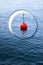 Lonely plastic red bouy on a calm lake - concept image