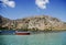 Lonely red boat and cretan mountains