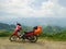 Lonely red motorbike parked on side road with beautiful view of mountains