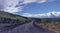 Lonely and remote rugged road, Piilani Hwy past Hana around south of Maui with Haleakala mountain, ocean and clouds in background