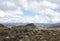 Lonely Rock Hill with frailejones and Andes Mountains on Sumapaz Paramo