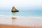 Lonely rock on the shore of Atlantic ocean in Algarve, Portugal