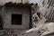 A lonely and sad guard dog on a chain near a dog house outdoors