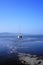 Lonely sailboat in crystal clear water