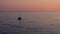 Lonely sailboat in the sea at sunset