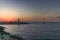 A lonely sailingboat returning to the harbour in Tel Aviv at sunset