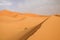 Lonely  sand dunes belt in the Sahara desert near Erg Chebbi, Morocco