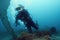 Lonely scuba diver and diver underwater view of the ocean floor with plants.