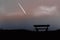 Lonely seat on the hill with white comet in beautiful sky