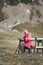 Lonely senior man sitting on bench being absorbed into his thoughts