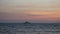 Lonely ship sail by the rippling endless Mediterranean sea at evening time complementing the wonderful landscape
