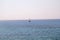 Lonely ship, sailboat at open sea. Calm sea allows best sailing in peaceful scene. Little sailing boat on turquoise sea.