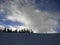 Lonely skier on a ridge of a ski slope