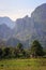 A lonely small wooden hut on a farm in Laos amid karst mountains