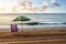 Lonely sunbed with umbrella on the seashore