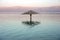 Lonely sunshade in the middle of the Dead Sea