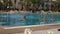 Lonely swimmer in swimming pool on resort, slow motion