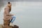 Lonely teenage girl sitting on the dock