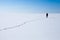 Lonely teenage girl walks along snowfield