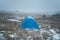 Lonely tent in the field. Winter time. Snowing