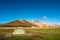 Lonely tent of a hiker in the Laugavegur multiday trail in Icelandic Landmannalaugar mountains, Iceland, blue sky, panoramic