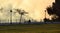 Lonely and thoughtful man sitting on a bench on the promenade with trees and street lamps on a sunset with a special light