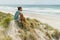 lonely thoughtful man sitting on seashore and looking at sea Rarawa beach