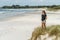 lonely thoughtful woman standing on seashore and looking at sea Rarawa beach