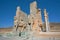 Lonely tourist watching the statues of ruined Persepolis city