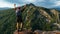 A lonely traveler with a backpack on the background of mountains, panorama. A male traveler in the mountains. A man in tourist