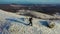 A lonely traveler walks along the top of a mountain range. Travel concept in extreme conditions. View from above.