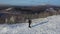 A lonely traveler walks along the top of a mountain range. Travel concept in extreme conditions. View from above.