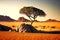 lonely tree in desert on sandy hill and large rock in background