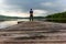 A lonely trekker on a jetty on the Saimaa lake in the Kolovesi N